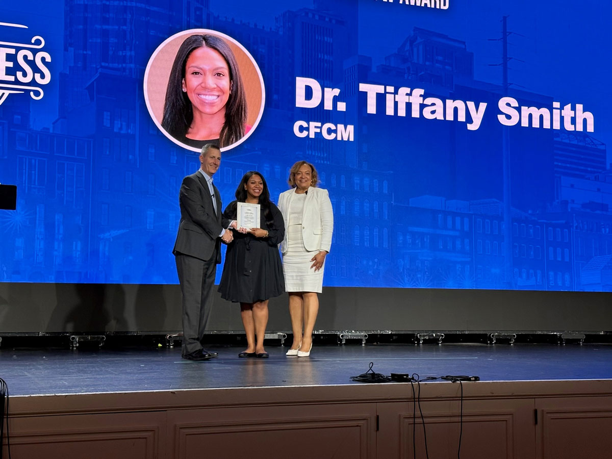 Tiffany Smith receiving NMCA award on stage
