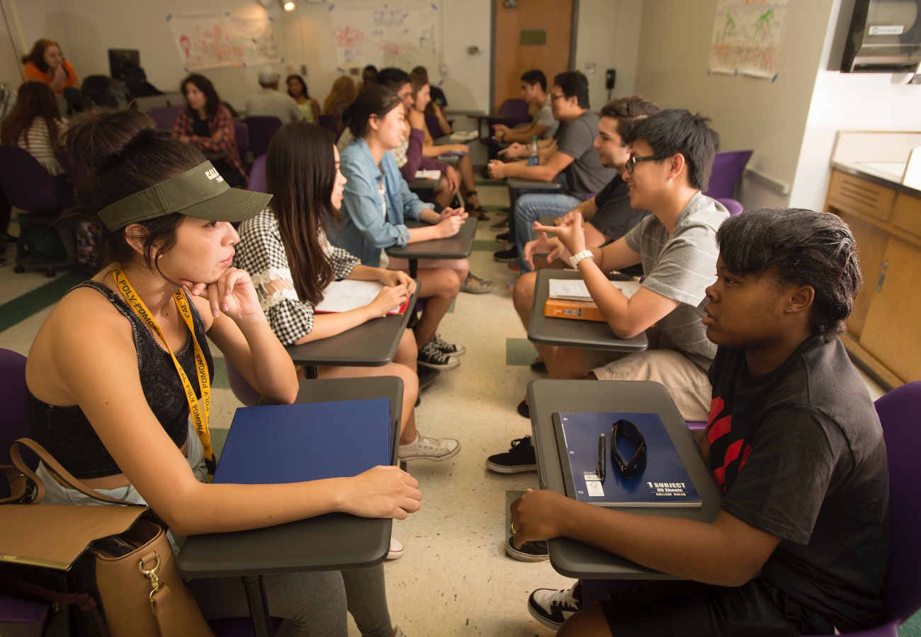 Students talking in a classroom. 