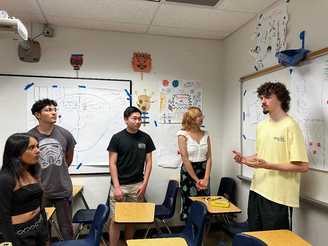 Students talking in a classroom.
