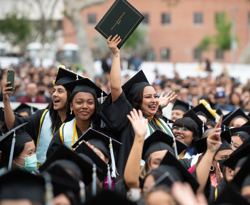 Students at graduation cheering. 