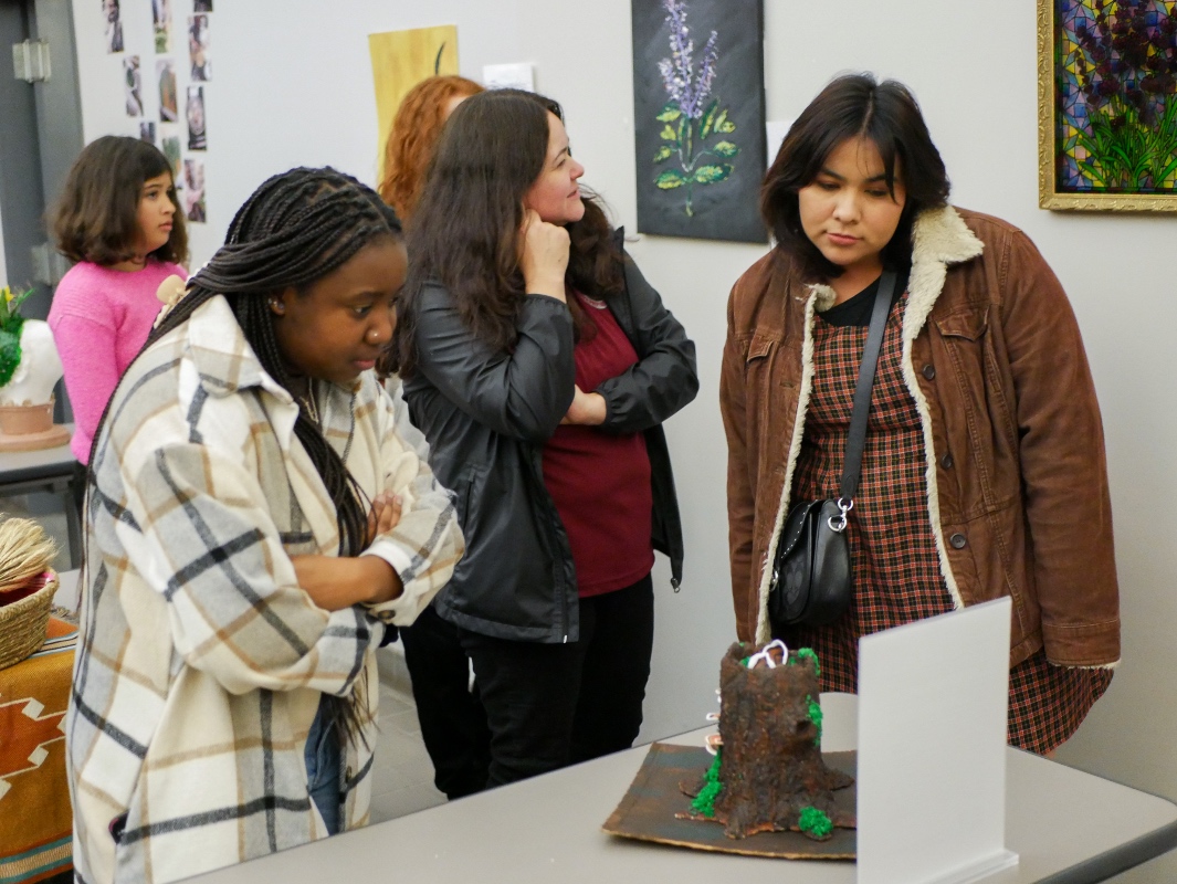 Liberal Studies students looking at fellow students final project. 