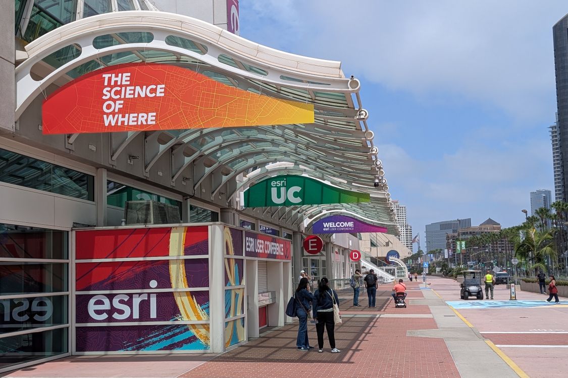 Hanging colorful Esri banners outside entrance to convention center