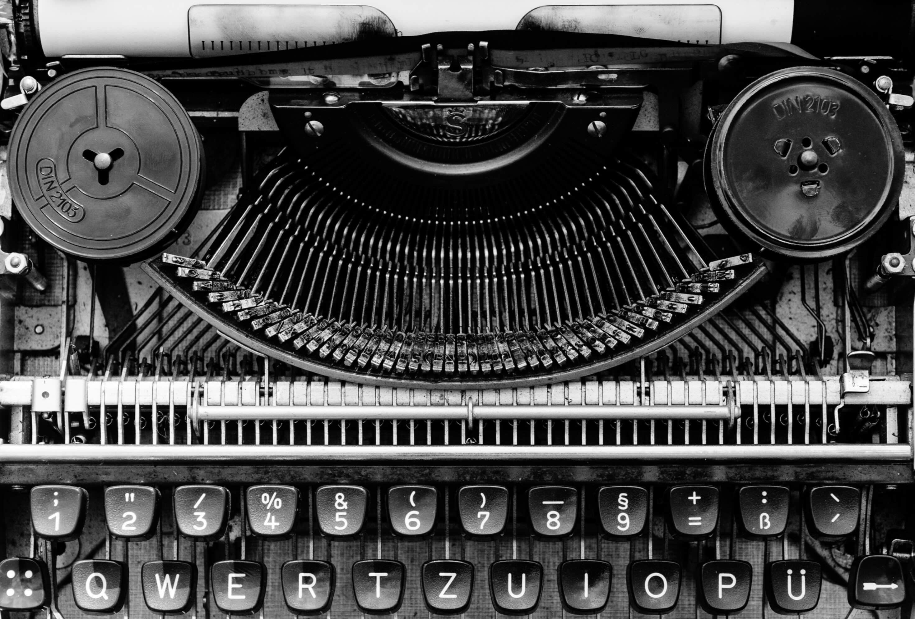 A black and white close up of an old-school manual typewriter