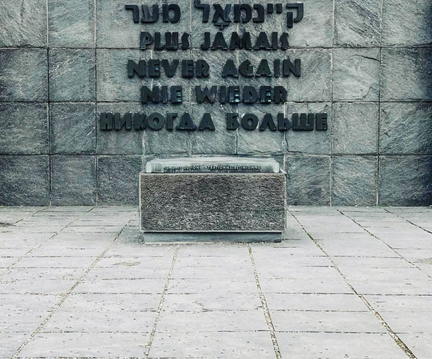 An image of a caption outside the concentration camps in Munich that reads "work will set you free" 
