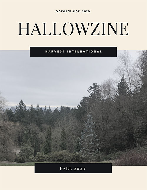 Hallowzine cover: Text saying 'October 31st, 2020. HALLOWZINE. HARVEST INTERNATIONAL. Fall 2020.' Image taken at the top of a hill, looking at pine trees, bare trees, and bushes. The sky is overcast, and the overall tone of the image is spooky.