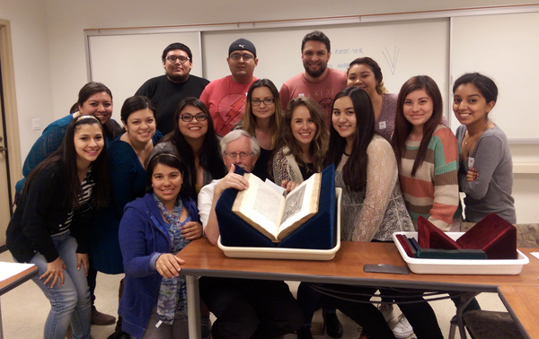 Students in the Early Modern Spanish Literature class with curator Stephen Tabor, and a copy of Ibarra's Quixote. 