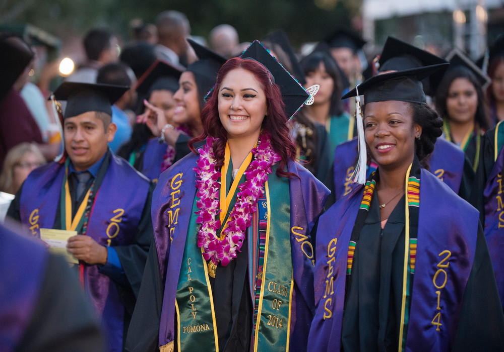 graduating student holding department banner