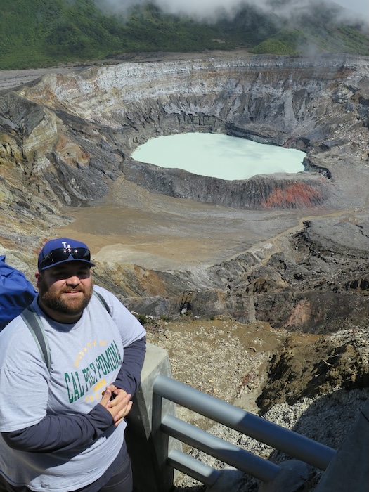Student standing near a crater