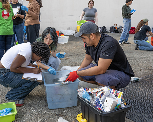 students going through trash