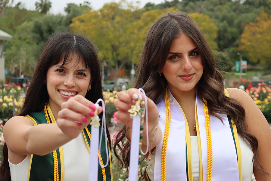 Natalie Khoury and Aubrey Schuster showing their Grad tassels