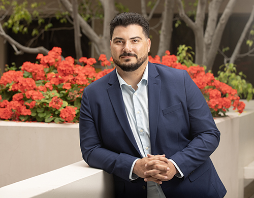 Jared Cuellar standing in courtyard of building 94