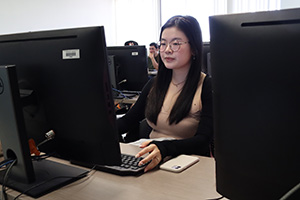 Elena working on a computer in a lab