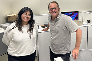 Student and professor smiling