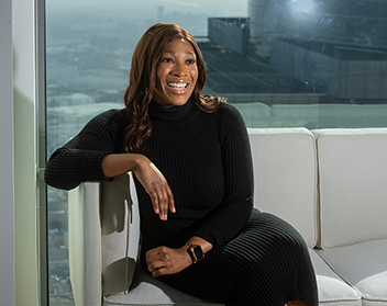 Watson sitting on a chair in a high rise building