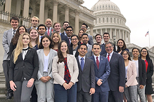 a group of Panetta Interns standing in front of a government building