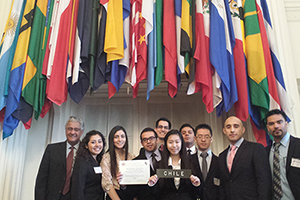 group of students in front of various flags