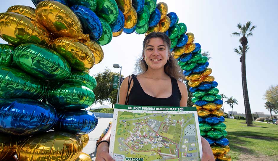 student under balloon arch