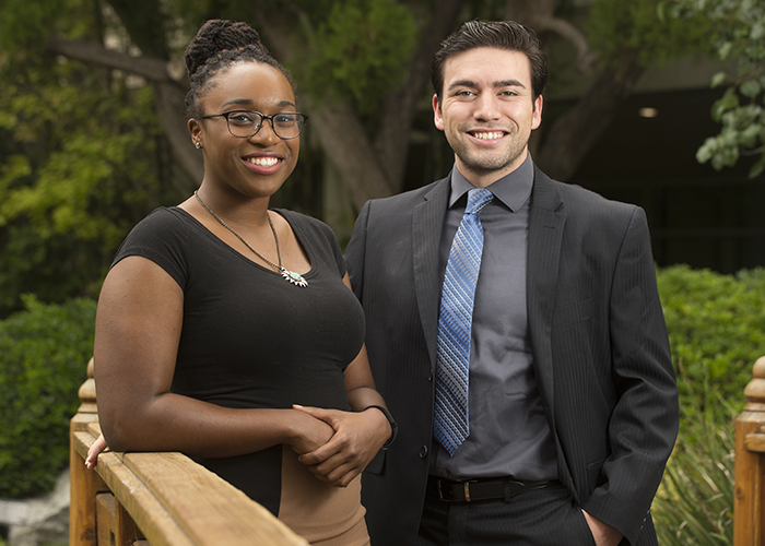 2 students standing on bridge