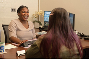 Student sitting with Advisor