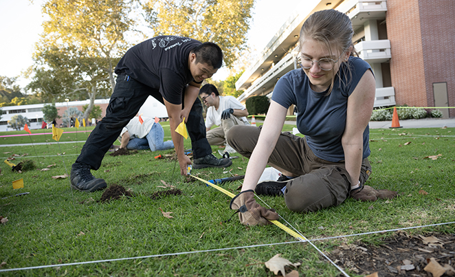 students measuring campus quad 