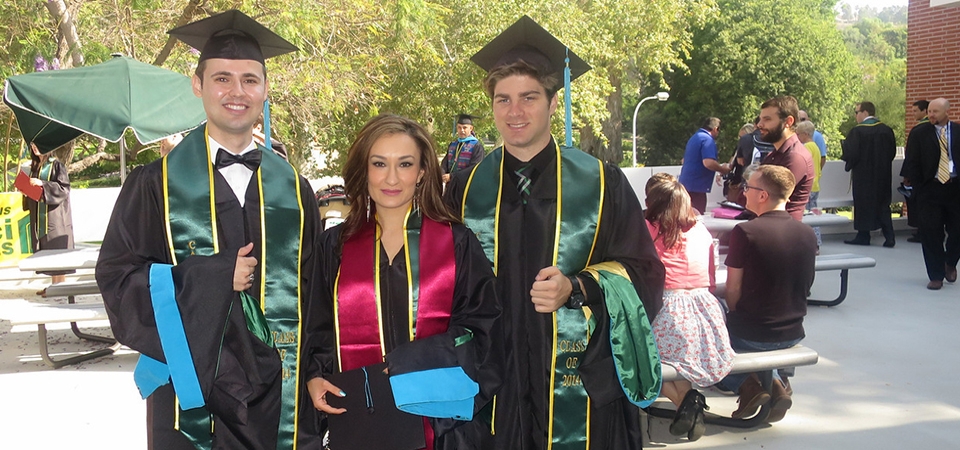 graduates posing for a photo before lining up to march