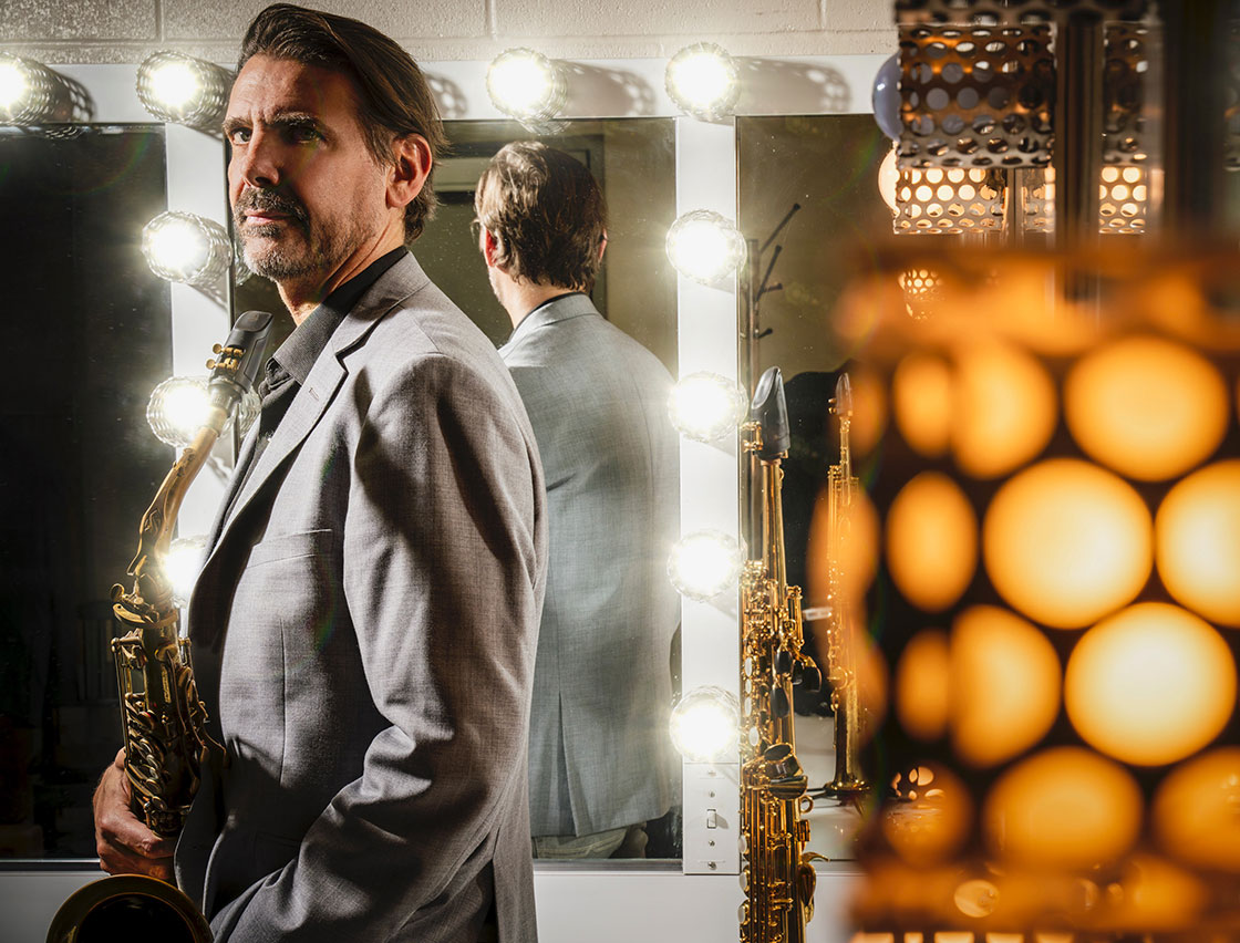 Tom Luer in front of a mirror with instrument