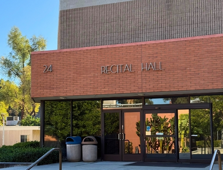 Entrance of Cal Poly Pomona Recital Hall with building number 24 and glass doors.