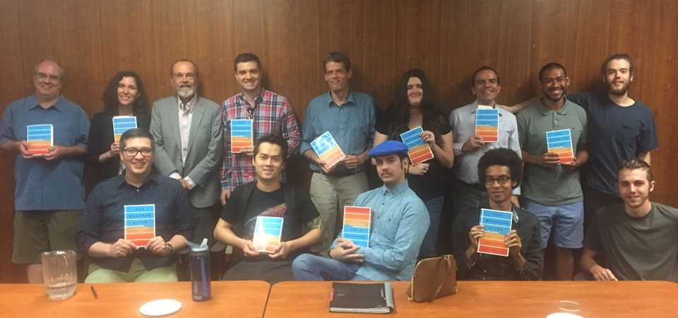 Photo of Philip Kitcher with CPP Philosophy faculty and students, holding copies of his book, which is entitled The Seasons Alter