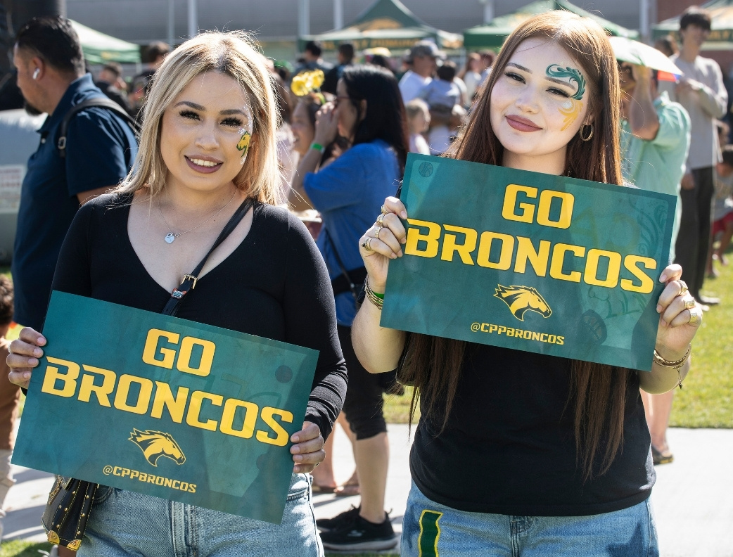 Two students holding up a Go Broncos Sign