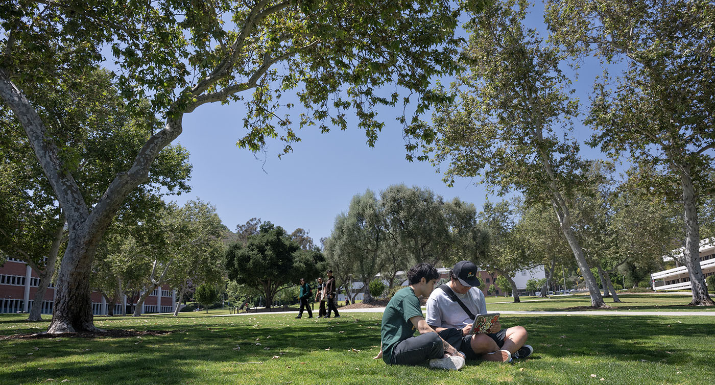 Two students are sitting in quad