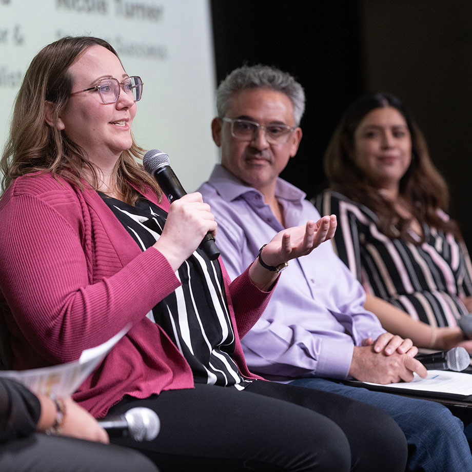 A panel of speakers participates in a discussion