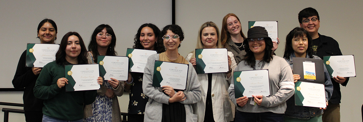 recipients holding their scholarship certificate