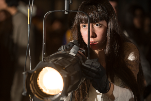 Student holding a stage lighting