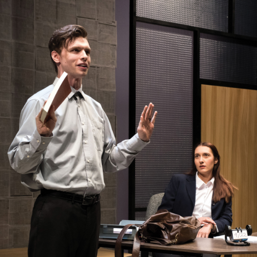 Student actor performs a monologue as another student actor watches in the play Boy Gets Girl