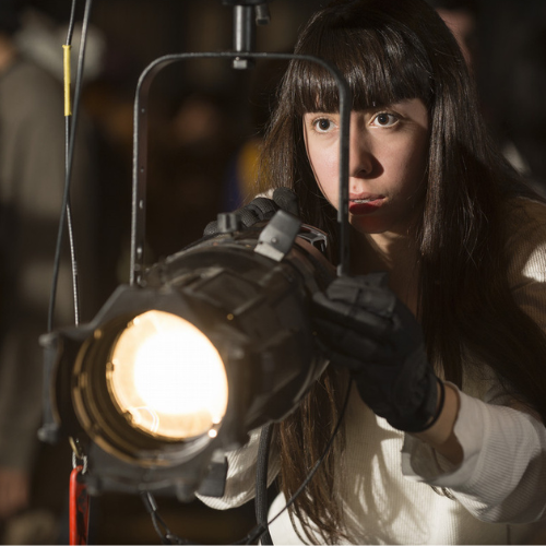 A high school student focuses a light during the tech olympics competition.