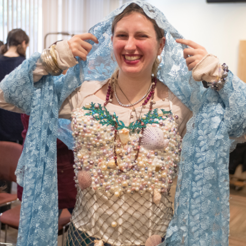 A student participates in a costume change game during the high school scene festival workshops.