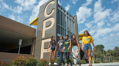 A group of students walking by the CPP mural at Parking Structure 2