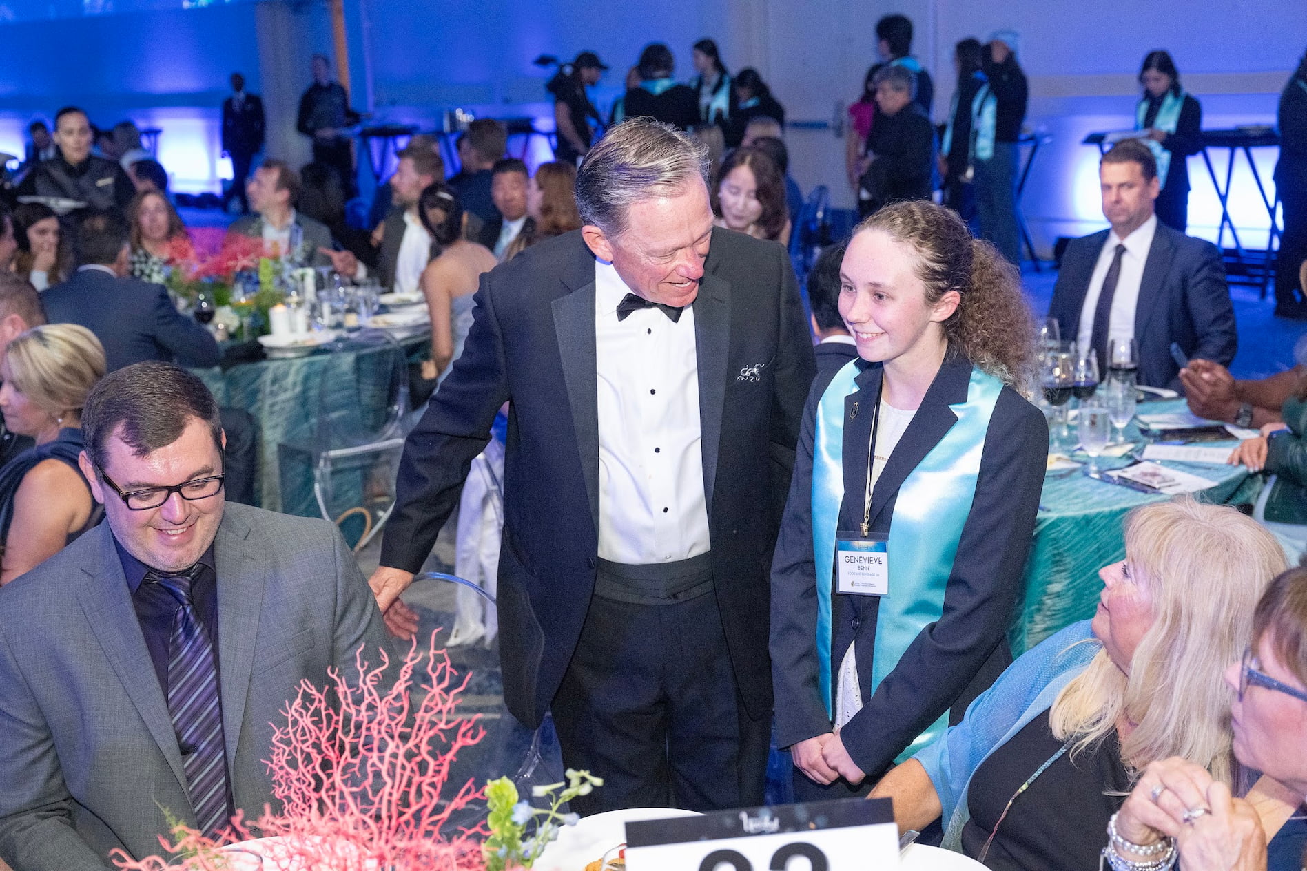 image of a host and student at a table at the hospitality uncorked gala