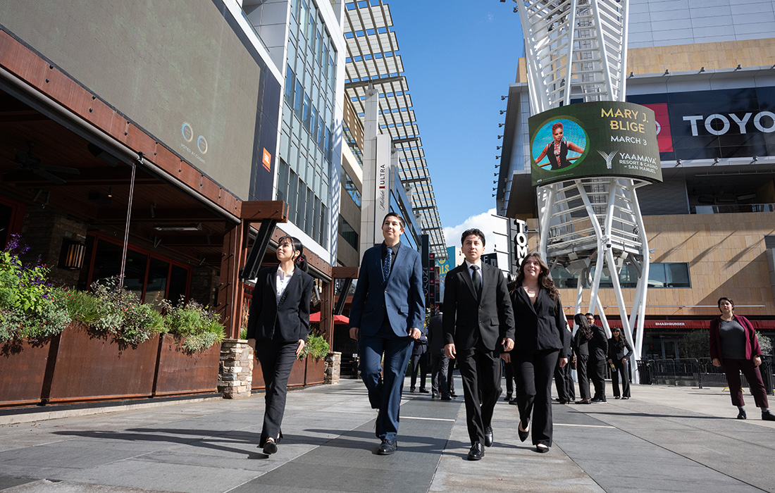 Students in professional attire walking in front of the Marriott