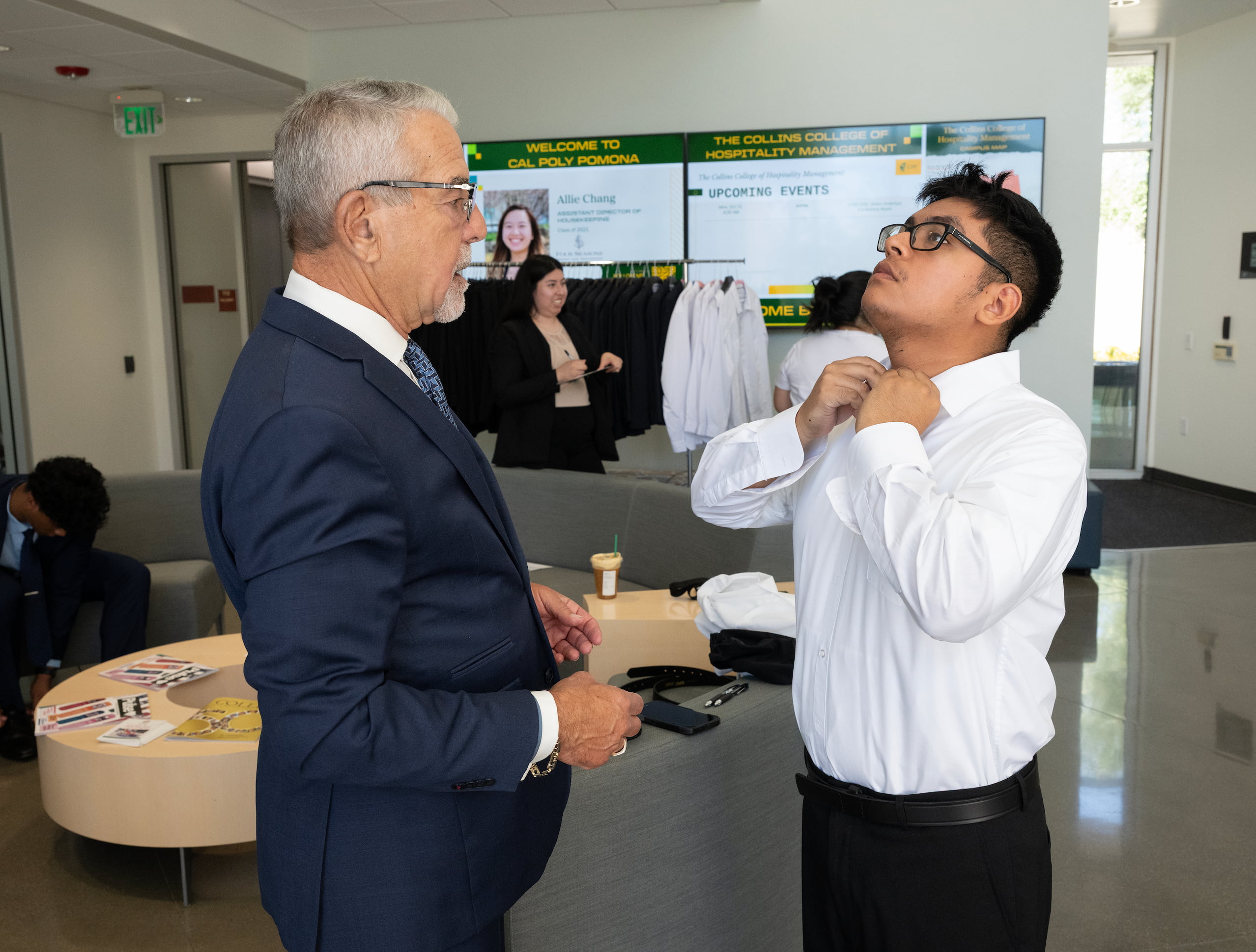 student fixing up his suit for the career fair