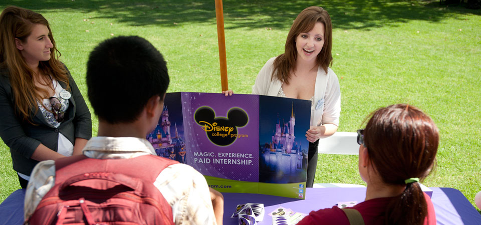a Disney rep speaks with students on the lawn.