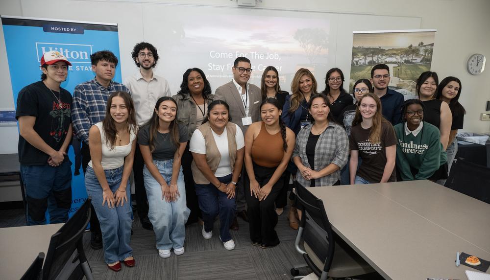 Hilton recruiters take a group photo with students after the info session.