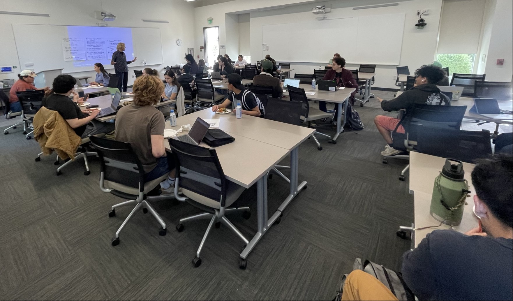 Margaret Bailey standing at the front of a classroom full of students.