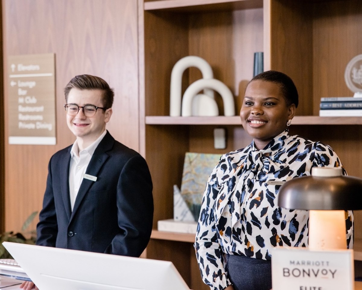 Two student workers at a hotel front desk