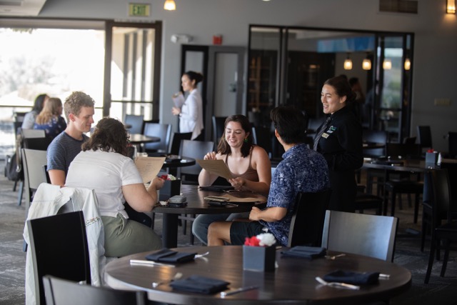 collins student taking guest orders 