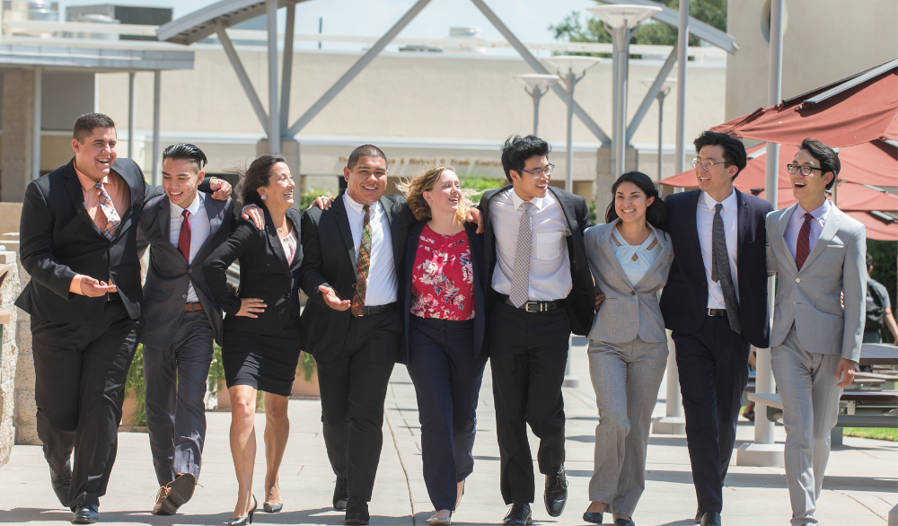 Collins students walk in front of college buildings
