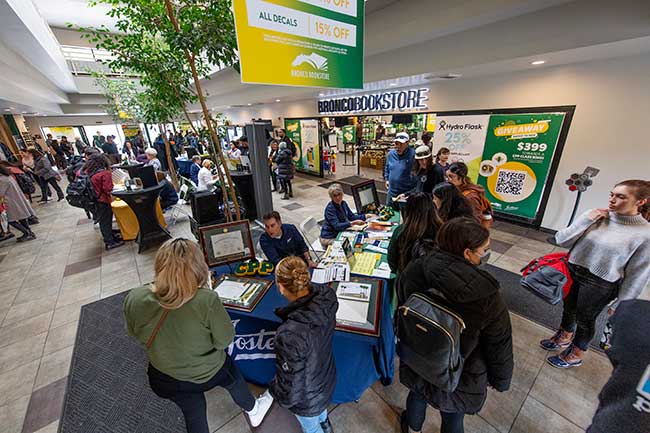 Students gather at the 2023 Grad Fair at the Bronco Bookstore