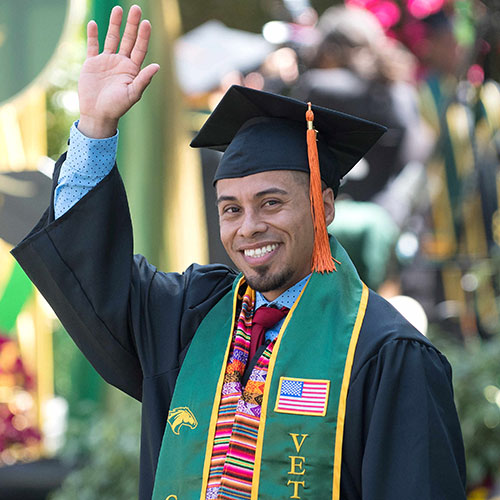 Male Veteran student smiles and waves during the 2018 engineering graduation