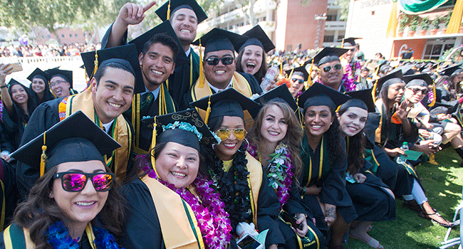 A group of college of science graduates celebrate during the 2018 commencement ceremonies