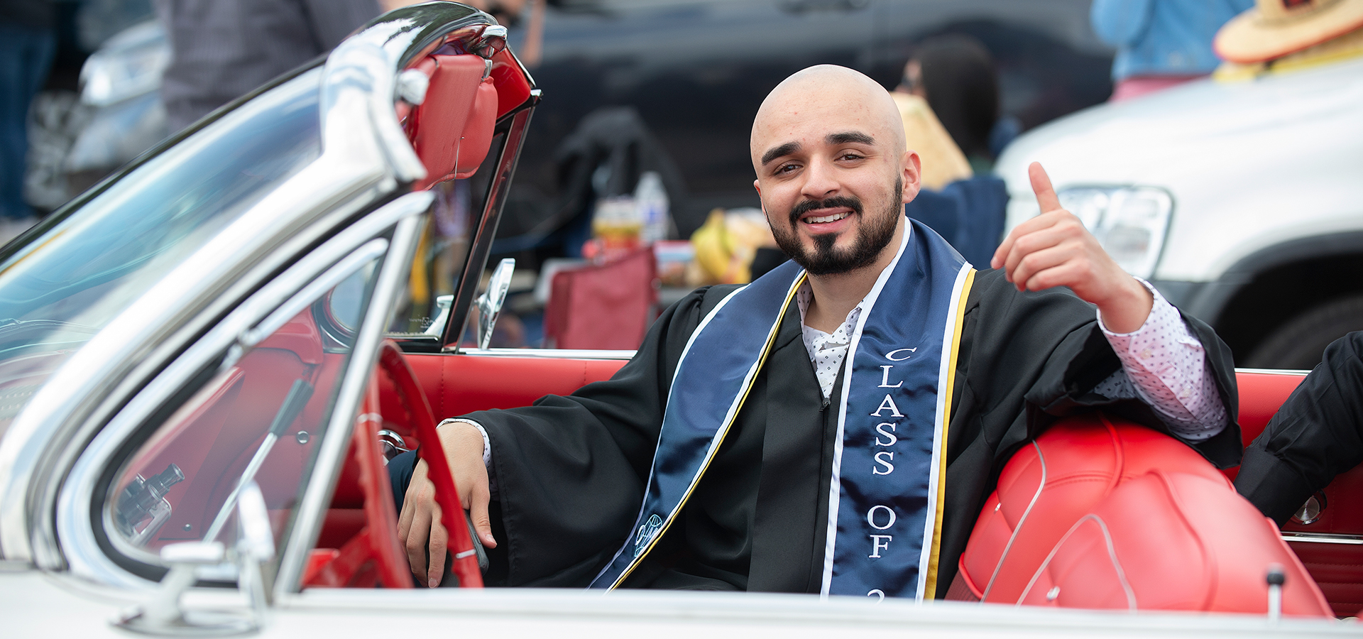 A college of business graduate waits in his car